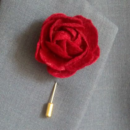 red mens lapel flower made from felt, on blue suit jacket