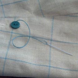 Changing a jacket button with needle and thread 