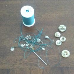 buttons, needle, spool, and thread 