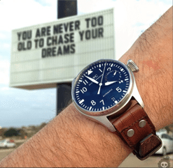 Instagram user @wristi showing off his watch in front of a billboard. @wristi, instagram user, displaying his watch in front of a billboard.