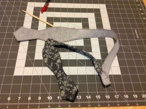 One side of bow tie fully pulled through to correct side