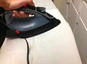 Man ironing interfacing onto fabric