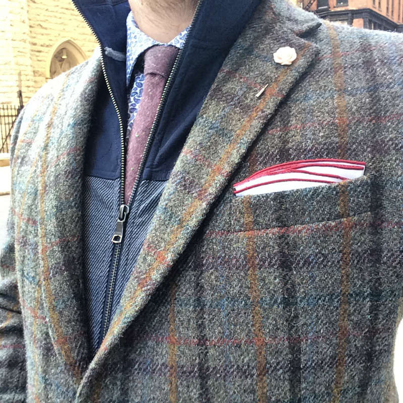 Man in tweed jacket with lapel flower