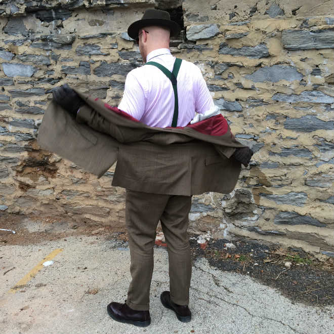 Putting on herringbone suit jacket