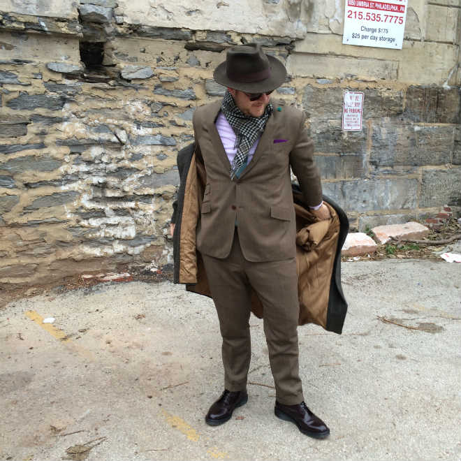 Putting on vintage overcoat