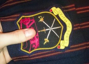 fixing blazer badge on breast pocket
