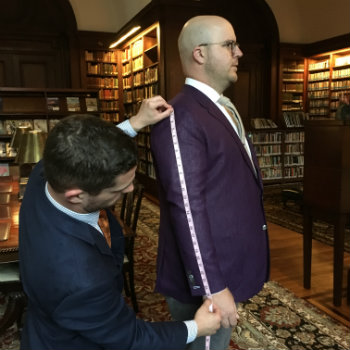 Man in purple jacket getting measured