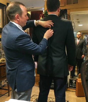 Man pinning suit jacket