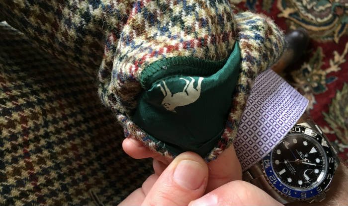 Turn-up cuff detail on tweed suit jacket