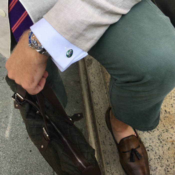 Man wearing silver and green enamel cufflinks