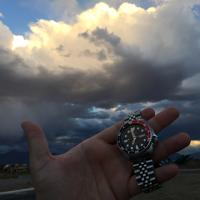 Watch with storm clouds in the background