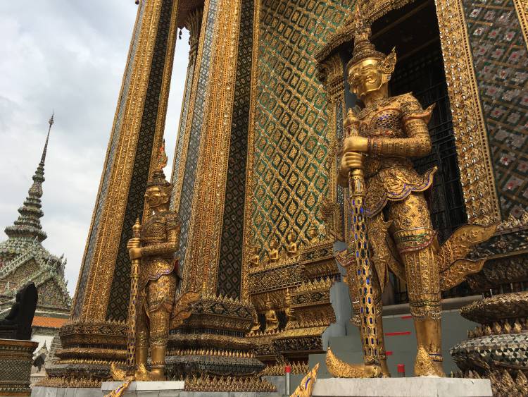 Gold statutes outside of temple doors