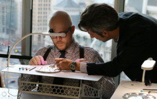 Vincent Robert helping Paul Anthony with watch