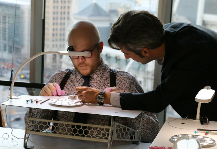 Vincent Robert helping Paul Anthony with watch