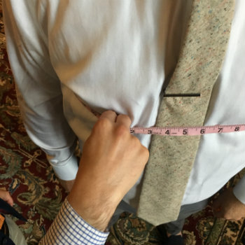pink measuring tape around white dress shirt
