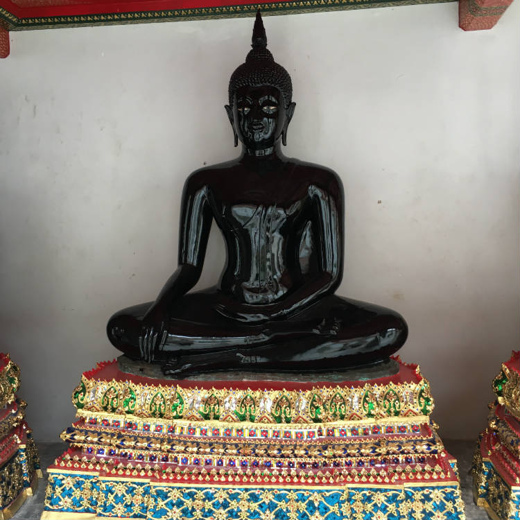 Black Buddhist Statue on golden base