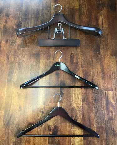 Three different suit hanger sizes