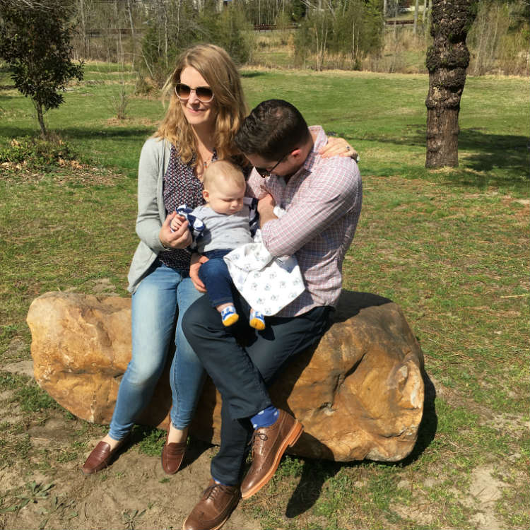 Man Woman And Baby On A Rock