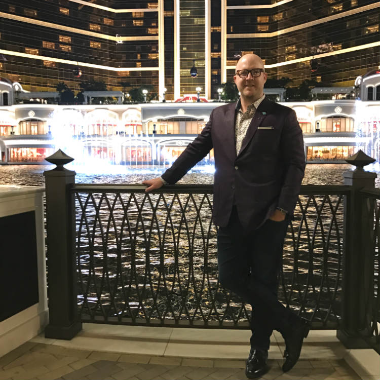Paul Anthony in suit outside Wynn Macau