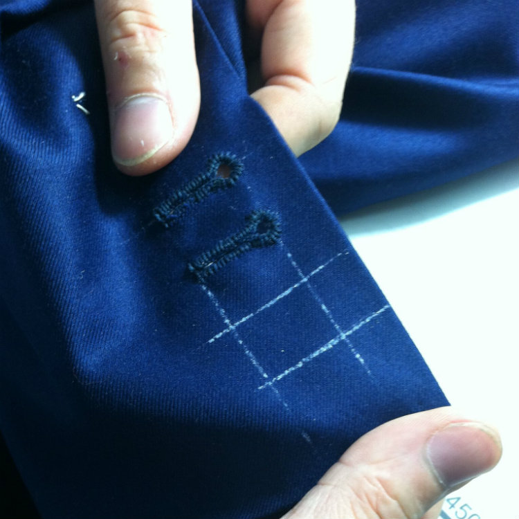 Tailor Showing Handsewn Jacket Sleeve Buttons