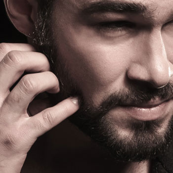 A Fashionable Man Scratching Itchy Beard