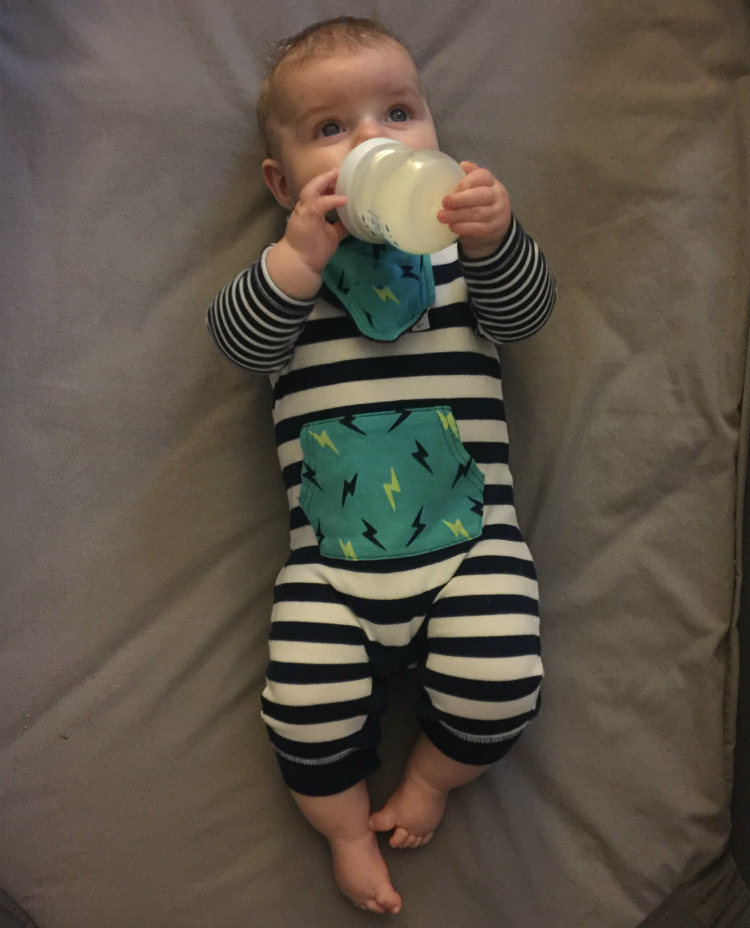 Baby In A Blue And White Onesie
