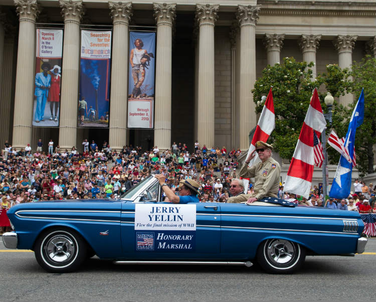 Man In Blue Car During Parade