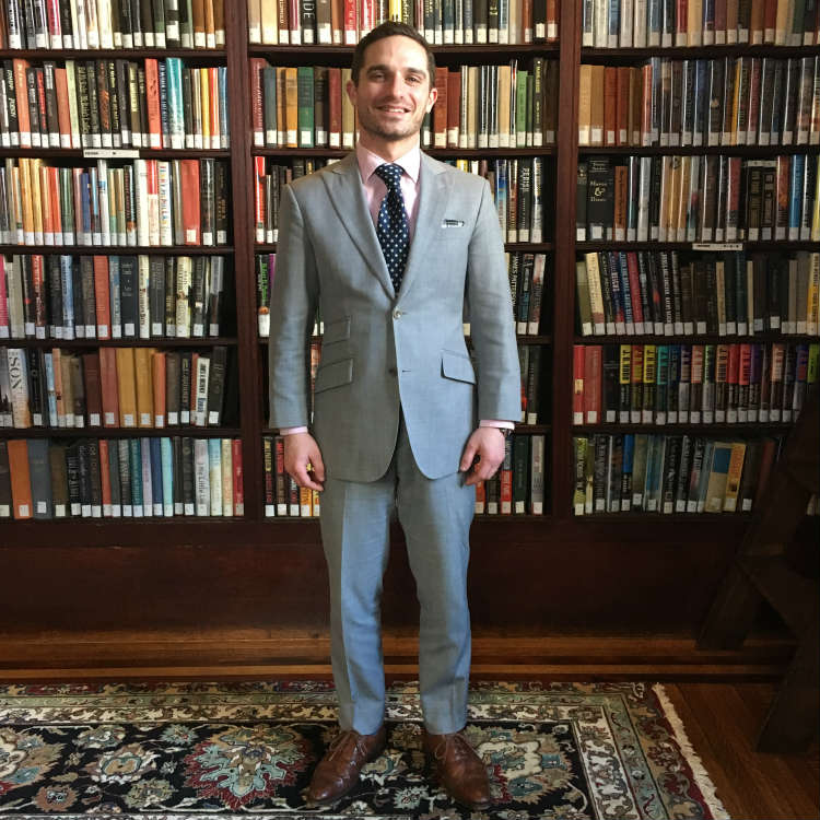 Man In Light Grey Suit In Library