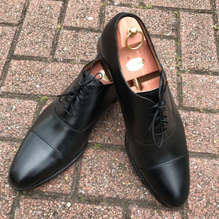 Black Cap Toe Oxfords On Brick