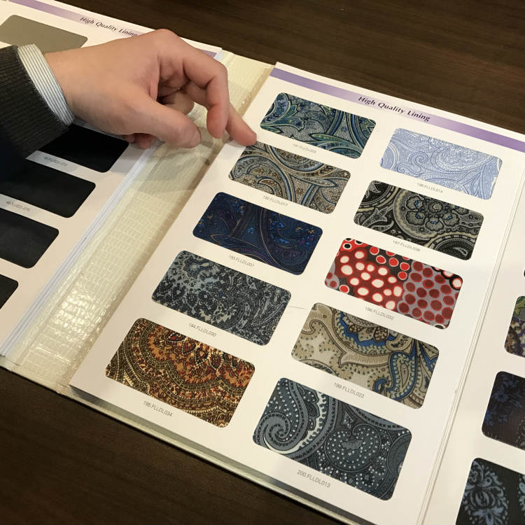 Hand Pointing To Suit Lining Swatch