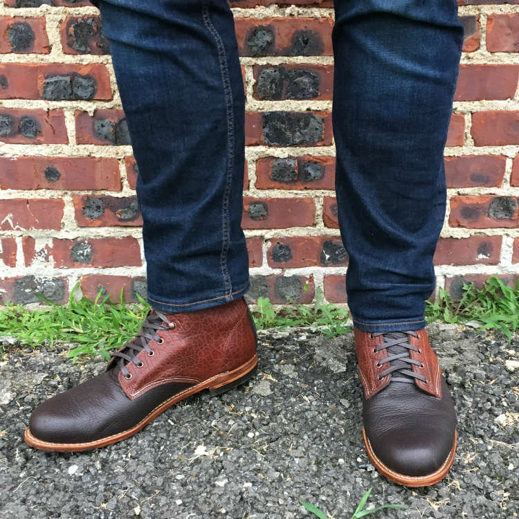 Jeans And Boots Against Brick