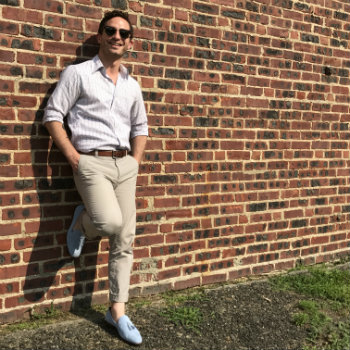 Man Against Brick Wall In Blue Shoes