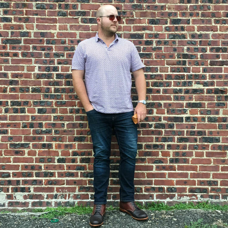 Man In Boots Against Brick Wall