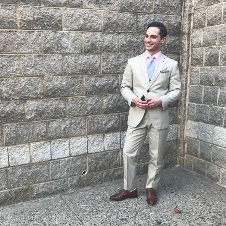 Man In Khaki Suit Against Grey Wall