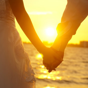 Couple-Holding-Hands-In-Sunset