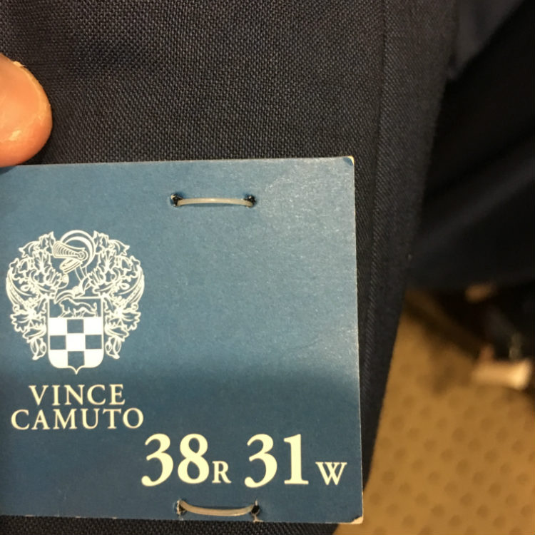 Sizing tag on grey suit