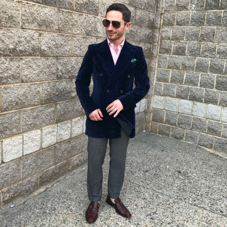 man in blue vintage coat and grey pants