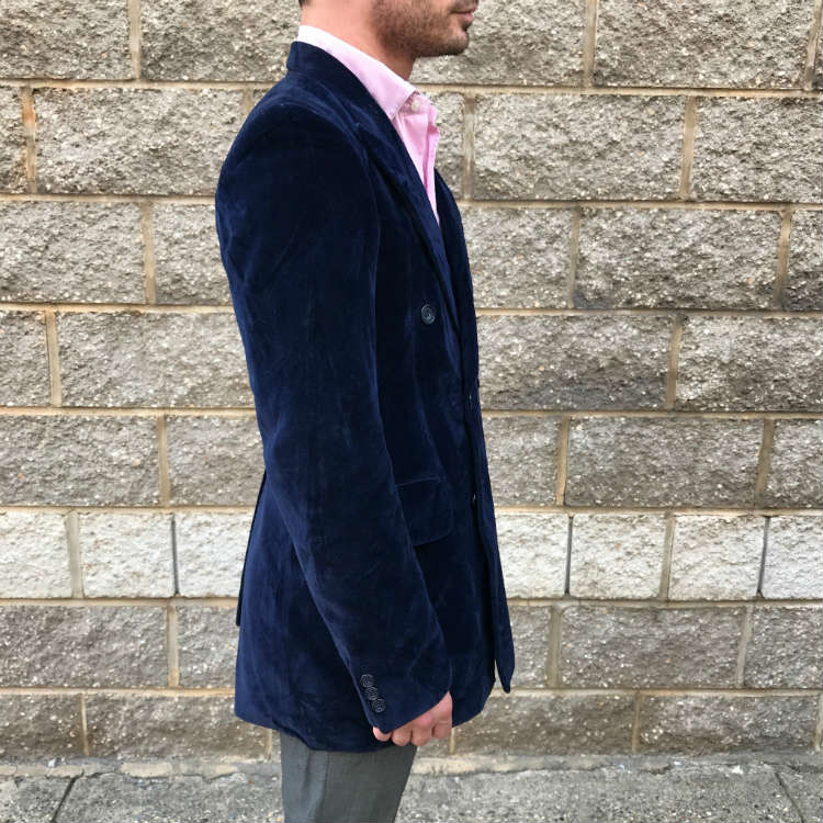 side of man in blue blazer