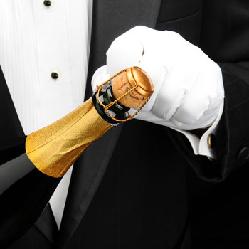 Waiter With White Gloves Unscrewing Champagne Wire Muselet