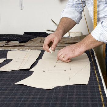 cutter tracing out pattern on fabric