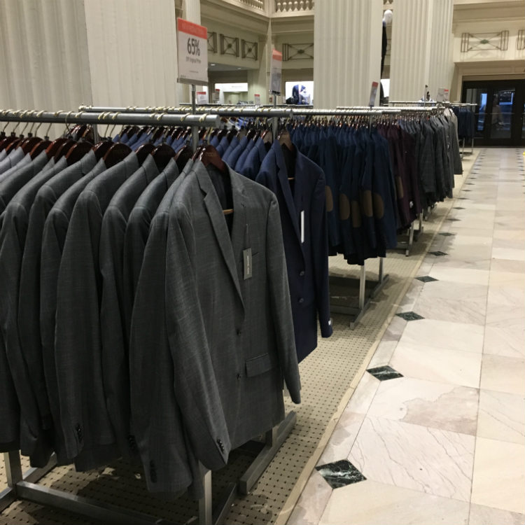 suits on racks in a store