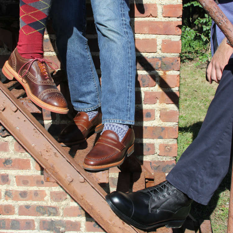 3 men modeling shoes on fire escape