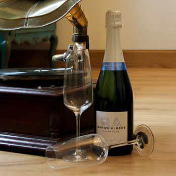 Baron Albert Universelle Champagne Bottle Next To A Gramophone