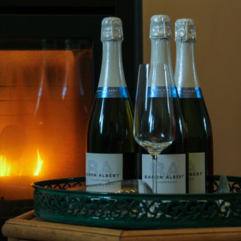 Baron Albert Universelle Champagne Bottles In Front Of A Fire