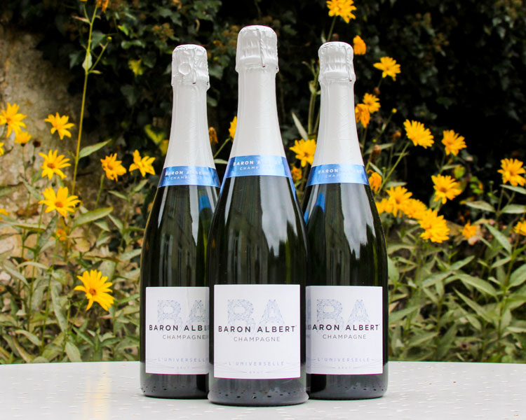 Baron Albert Universelle Champagne Bottles In Front Of Yellow Flowers