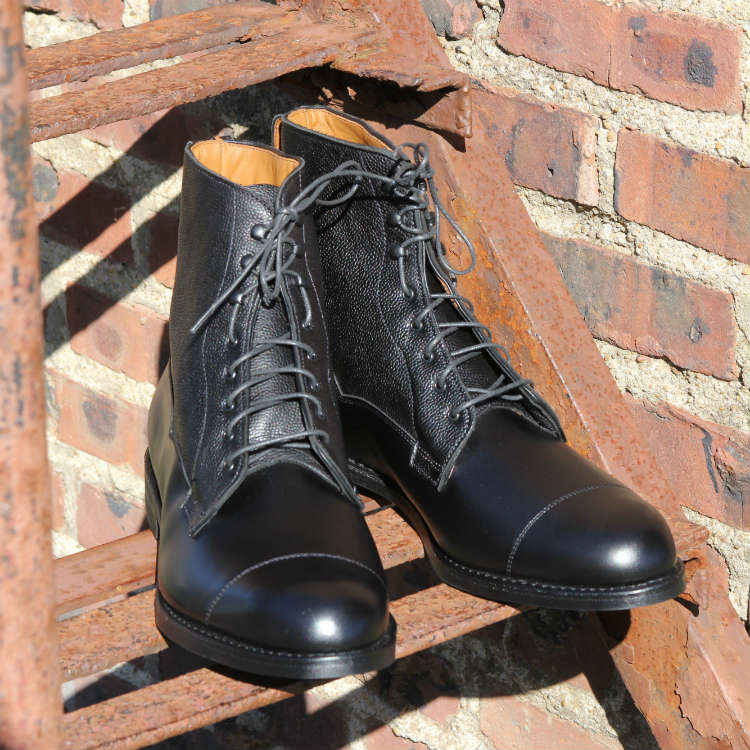 black allen edmonds boots on fire escape