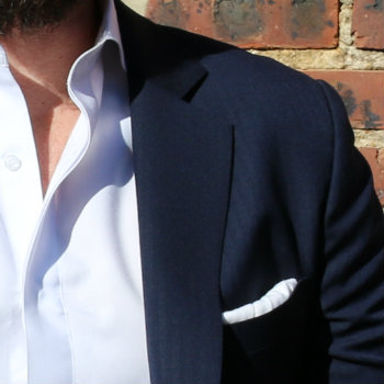 blue jacket with white pocket square