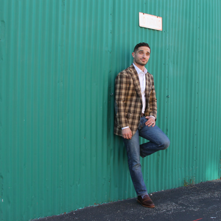 man standing against green wall