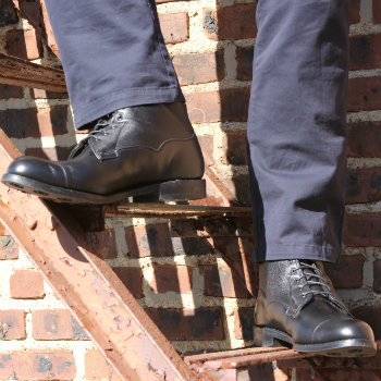 Black Allen edmonds boots with blue pants