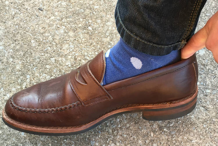 finger in heel of penny loafer